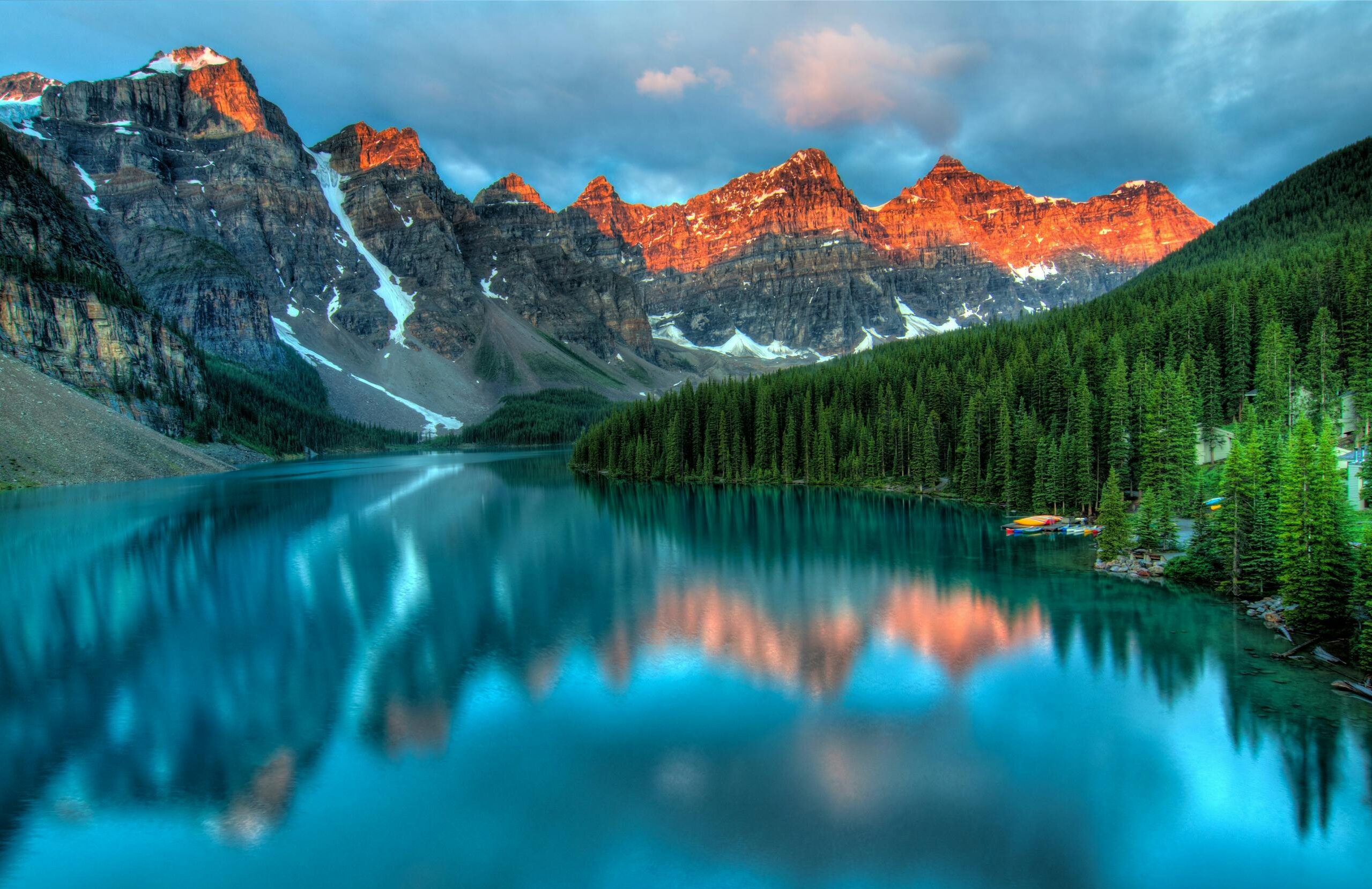 Capture the serene beauty of Moraine Lake with sunrise reflections in Banff National Park.